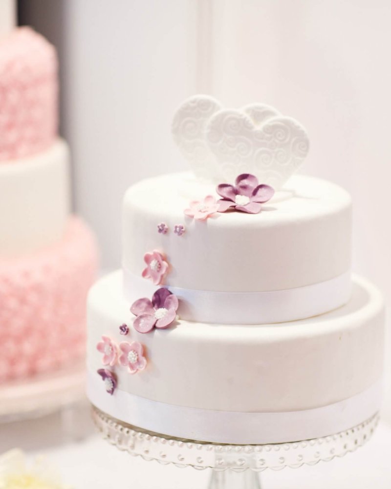Delicious beautiful wedding cake in white creme and pink.